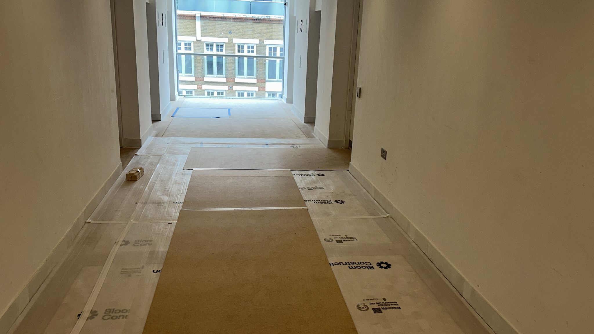 Circulation corridor with Bloom Construction floor protection during handover